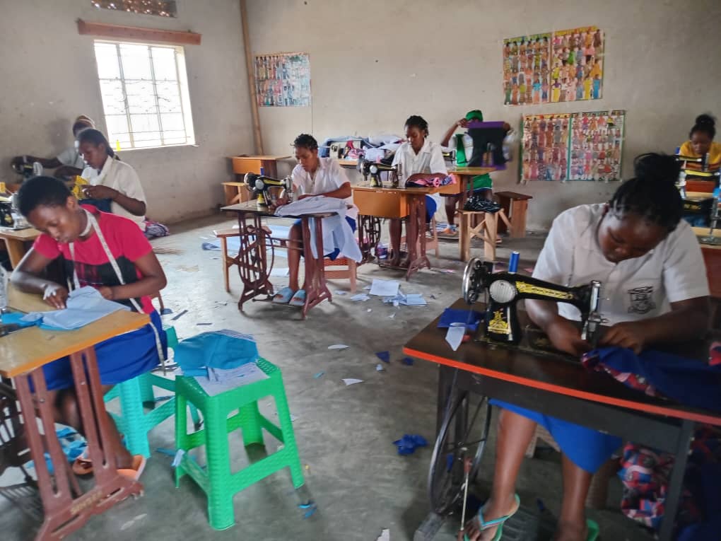 Learners working at sewing machines in a tailoring classroom